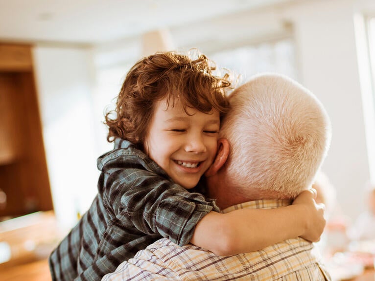 grandchild hugging grandparent
